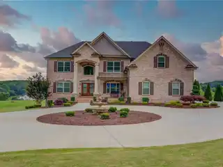 Grand Two-Story Foyer with Rich Hardwood Floors