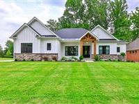 CUSTOM NEW FOUR BEDROOM RANCH ON A WOODED LOT