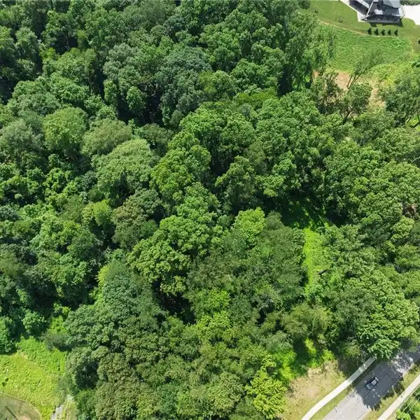 LUXURY LIVING ON 3 WOODED ACRES AWAITS