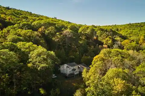 Serene Estate Surrounded by Forest and Rock Outcroppings