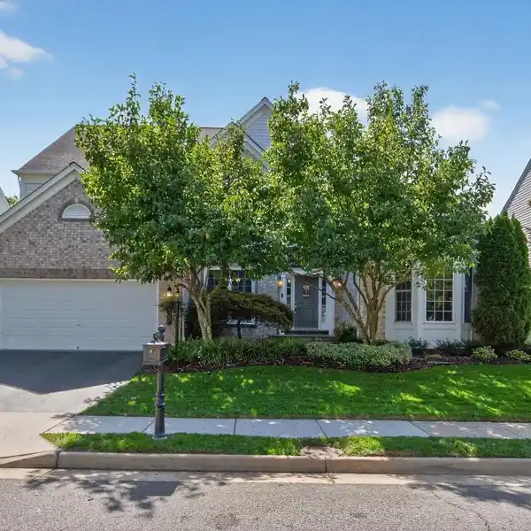 REFINED LIVING WITH DUAL SUITES AND SUNROOM CHARM