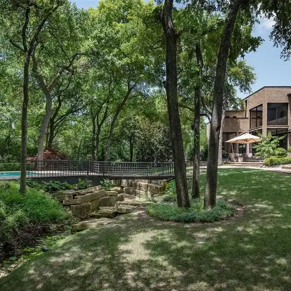 CONTEMPORARY RETREAT WITH DESIGNER TOUCHES AND LUSH LANDSCAPING