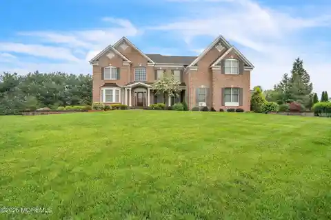 Brick Front Beauty with Dramatic Curved Staircase