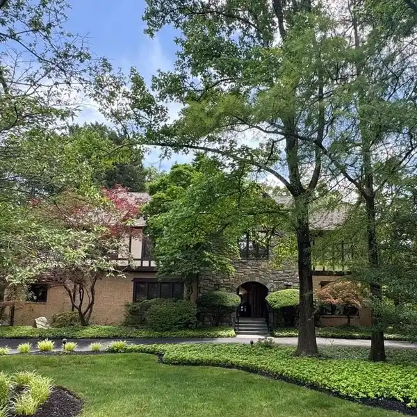 CUSTOM-BUILT BRICK AND STONE TUDOR