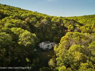 Serene Estate Surrounded by Forest and Rock Outcroppings