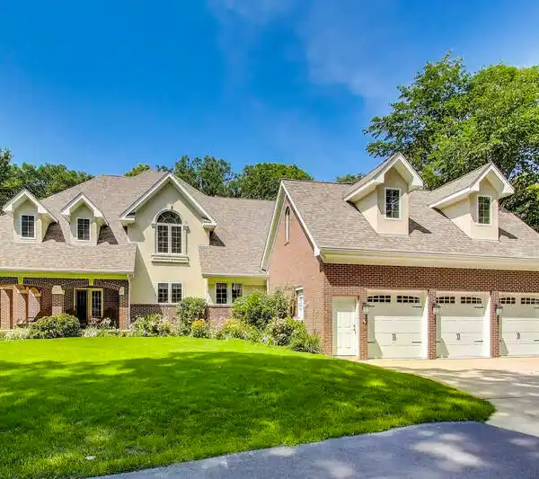 STUNNING TWO-STORY BRICK RESIDENCE PERCHED ON A SCENIC HILL