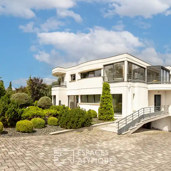 SPACIOUS HOME SURROUNDED BY PRIVATE WOODED GROUNDS