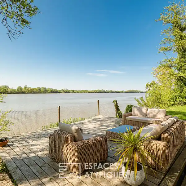 VAST STONE HOUSE NESTLED ON THE BANKS OF A RIVER