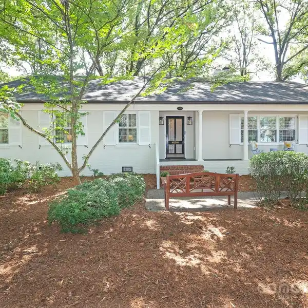 CHARMING ONE AND A HALF STORY HOME ON A PRIVATE CORNER LOT
