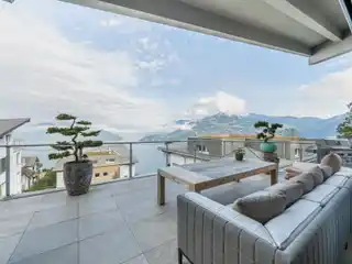 Breathtaking Panorama of Shimmering Lake and Majestic Alpine Peaks