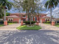LUXURIOUS TWO-STORY MEDITERRANEAN ESTATE WITH A DOUBLE GATED ENTRY
