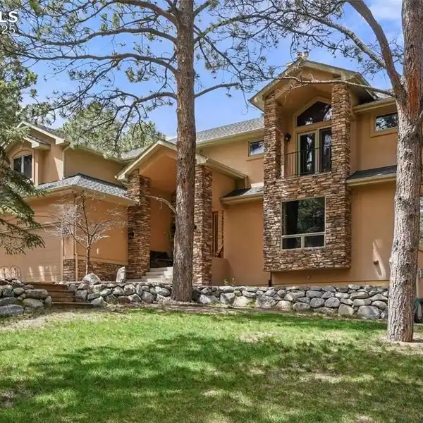 LUXURY HOME ON A WOODED LOT IN WOODMOOR