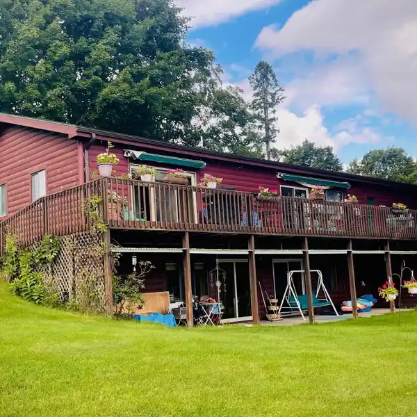 LOG SIDED DUAL LEVEL LAKE HOME