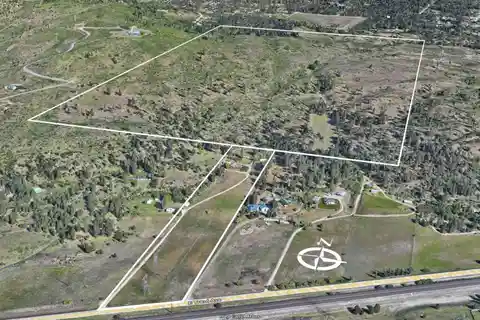 Huge Acreage with Farmhouse and Multiple Outbuildings