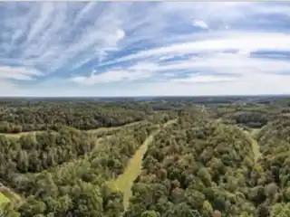 Expansive Hilltop Farmstead with Scenic Pastures