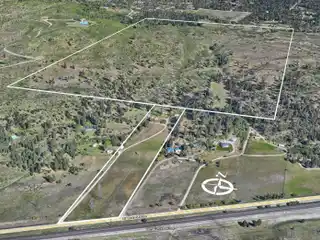 Huge Acreage with Farmhouse and Multiple Outbuildings