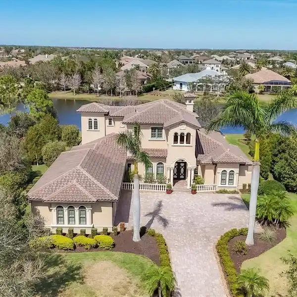 METICULOUSLY MAINTAINED ESTATE HOME IN THE EXCLUSIVE LAKE CLUB AT LAKEWOOD RANCH