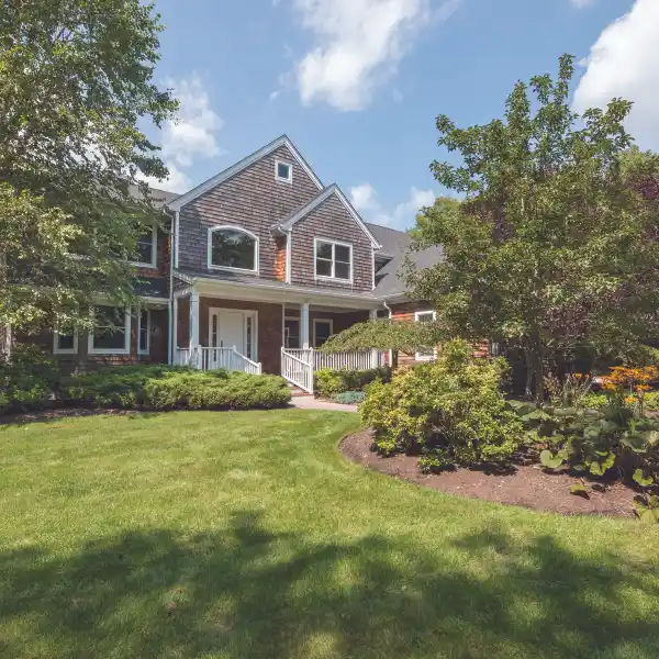 REFINED QUOGUE RETREAT WITH TENNIS AND POOLSIDE LUXURY