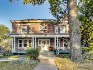Timeless Riverside Elegance with Iconic Front Porch & Modern Upgrades