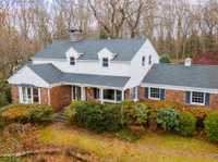METICULOUSLY MAINTAINED RETREAT ON TWO WOODED ACRES