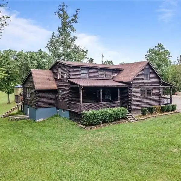 CHARMING LOG HOME ON 24-PLUS ACRES
