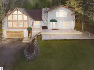 Fully Furnished Lake Charlevoix Home with Dock, Pole Barn & Stunning Views