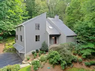 Modern Comfort Enveloped by Wooded Privacy