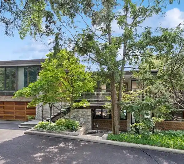 SLEEK MID-CENTURY MODERN HOME ON A LUSH LOT