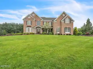 Brick Front Beauty with Dramatic Curved Staircase
