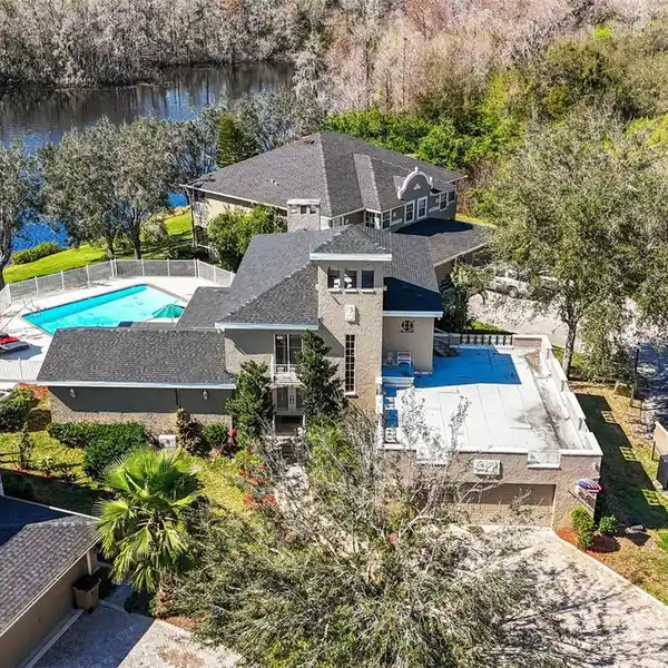 THREE-LEVEL POOL HOME ON THE SERENE HILLSBOROUGH RIVER