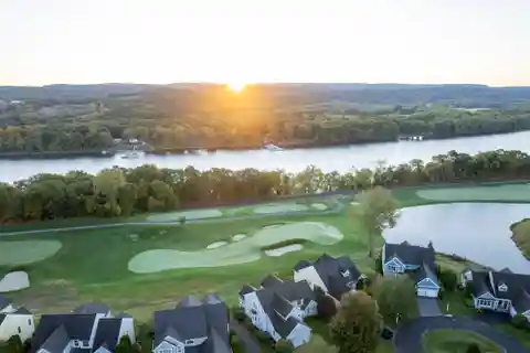 Fairway-Facing Estate with Riverfront Serenity