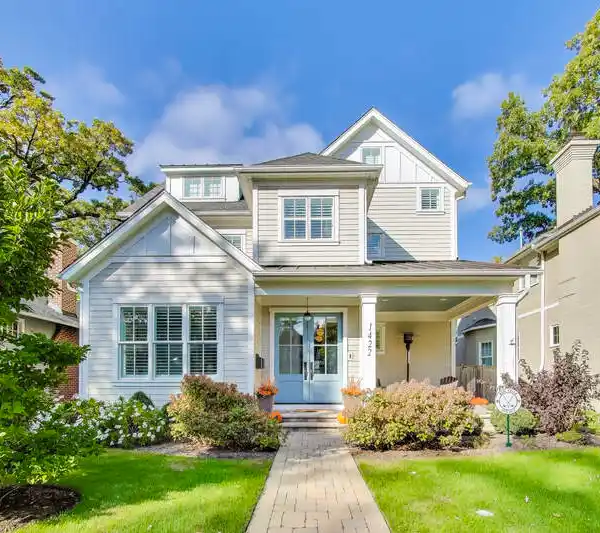 WELCOMING FRONT PORCH WITH STUNNING BLUE DOUBLE DOORS