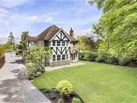 LIGHT AND AIRY TUDOR REVIVAL HOME WITH SPACIOUS ACCOMMODATIONS