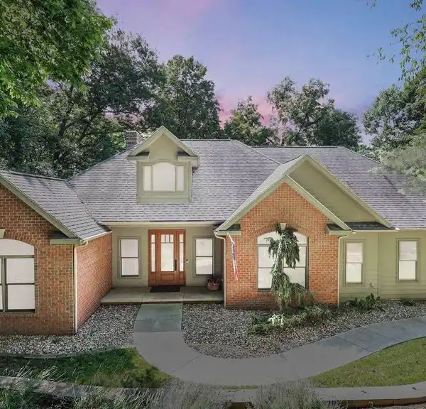 CUSTOM RANCH HOME ON A PRIVATE WOODED LOT