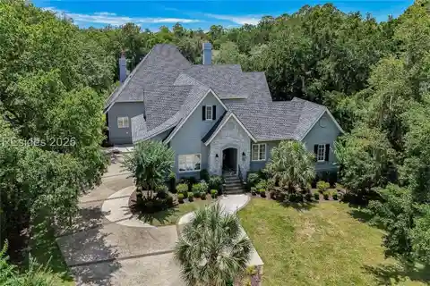 Step into the Charm of Lowcountry Living with This Beautifully Renovated Retreat on a Serene Saltwater Lagoon in the Prestigious Colleton River Club.