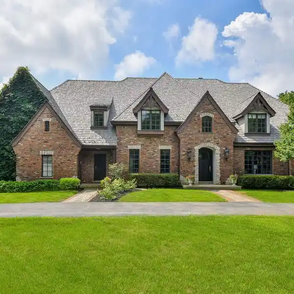 STATELY ALL-BRICK HOME FRAMED BY CIRCULAR DRIVEWAY