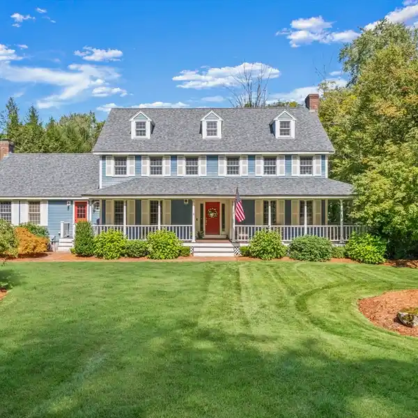 CENTER-ENTRANCE COLONIAL WITH DREAMY WRAP-AROUND PORCH