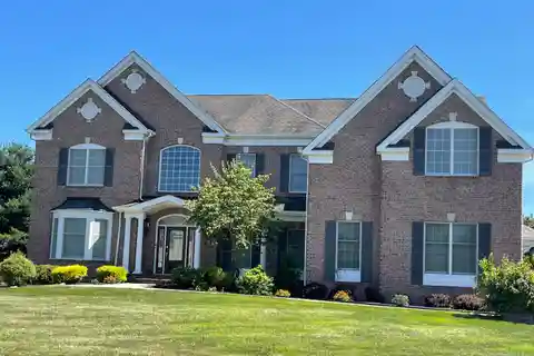 Brick Front Beauty with Dramatic Curved Staircase
