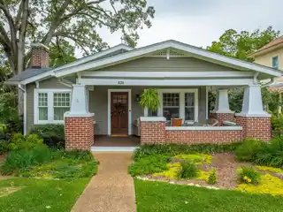Elegant Home with Front Porch and Lush Landscaping