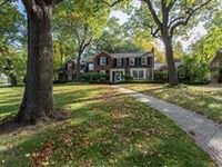 SPRAWLING COLONIAL IN THE WOODS