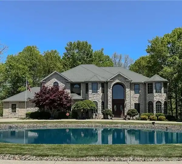 EXCEPTIONAL RESIDENCE ON OVER FIVE WOODED ACRES