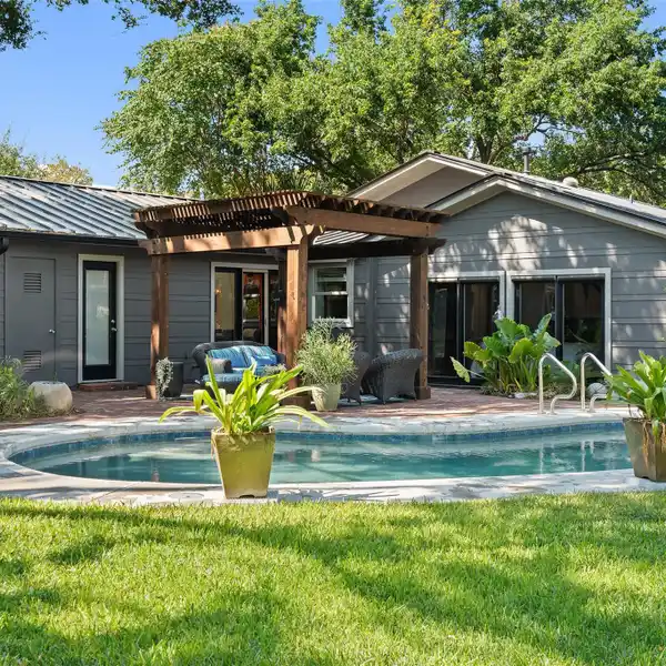 UPDATED MID-CENTURY MODERN HOME ON A PRIVATE LOT IN BARTON HILLS
