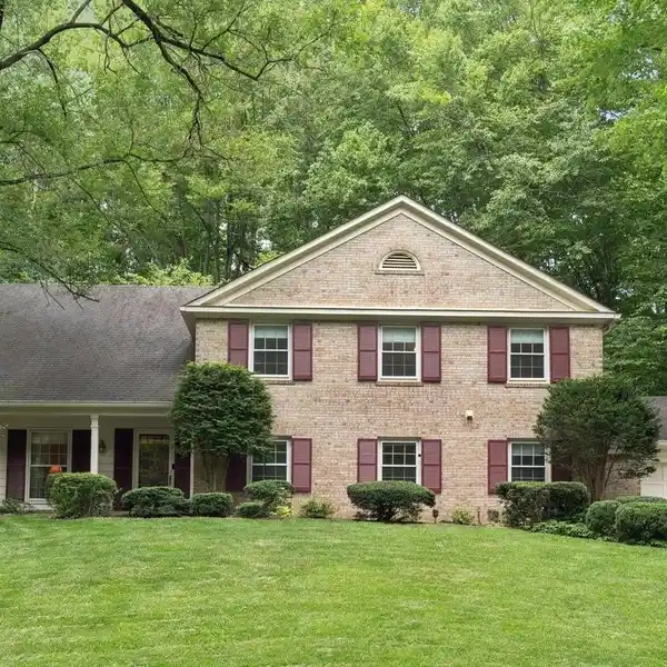 STATELY COLONIAL OVERLOOKING SERENE WOODED GREEN SPACE
