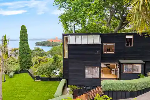 Architectural Coastal Haven Framed by Majestic Oak