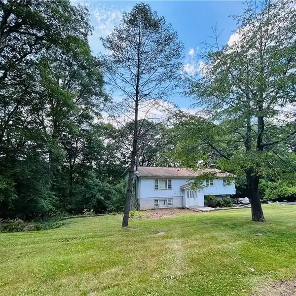 OVERSIZED HOME ON EXPANSIVE PROPERTY