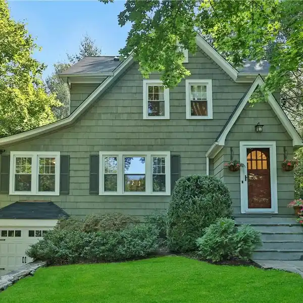 RENOVATED STORYBOOK 1930S-ERA TUDOR-STYLE SHINGLE COTTAGE