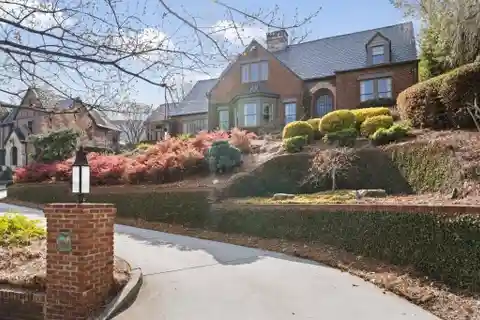 Brick Tudor Home with Carriage House