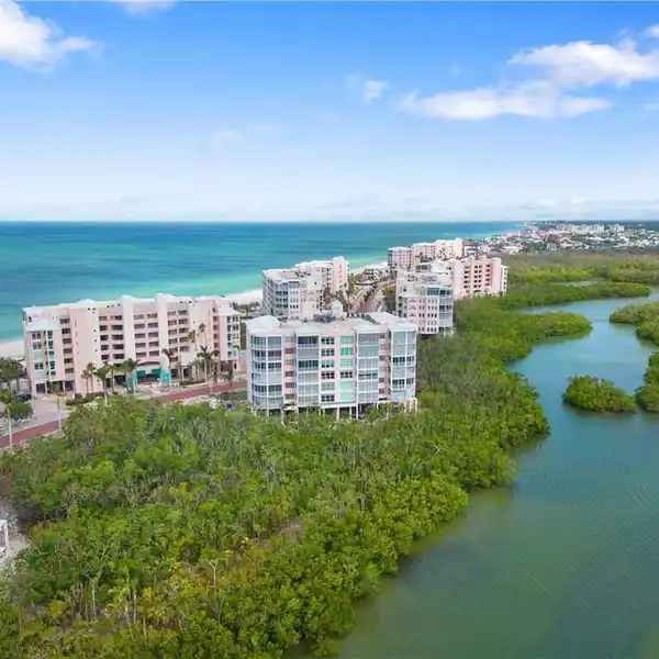 END-UNIT WITH SPECTACULAR BAY AND PARTIAL GULF VIEWS