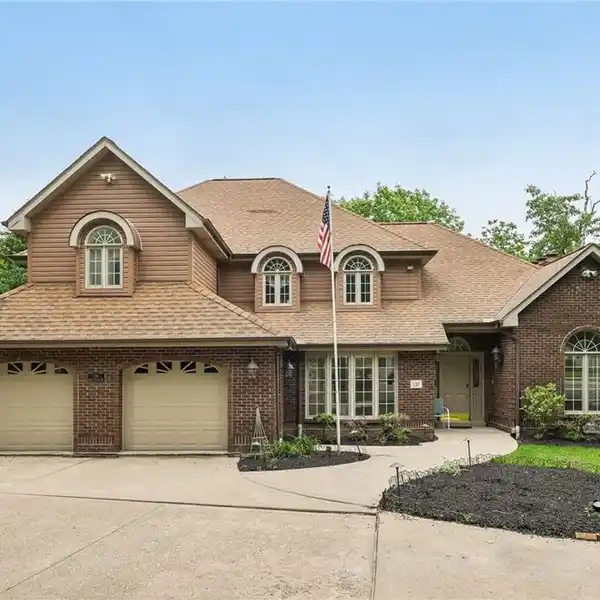 CUL-DE-SAC WOODED RETREAT WITH 5-CAR GARAGES