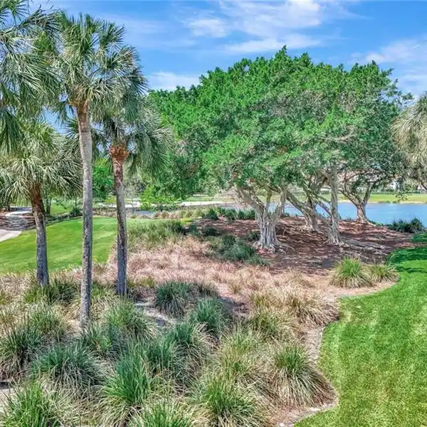 UPPER-FLOOR END UNIT WITH PANORAMIC GOLF AND WATER VIEWS